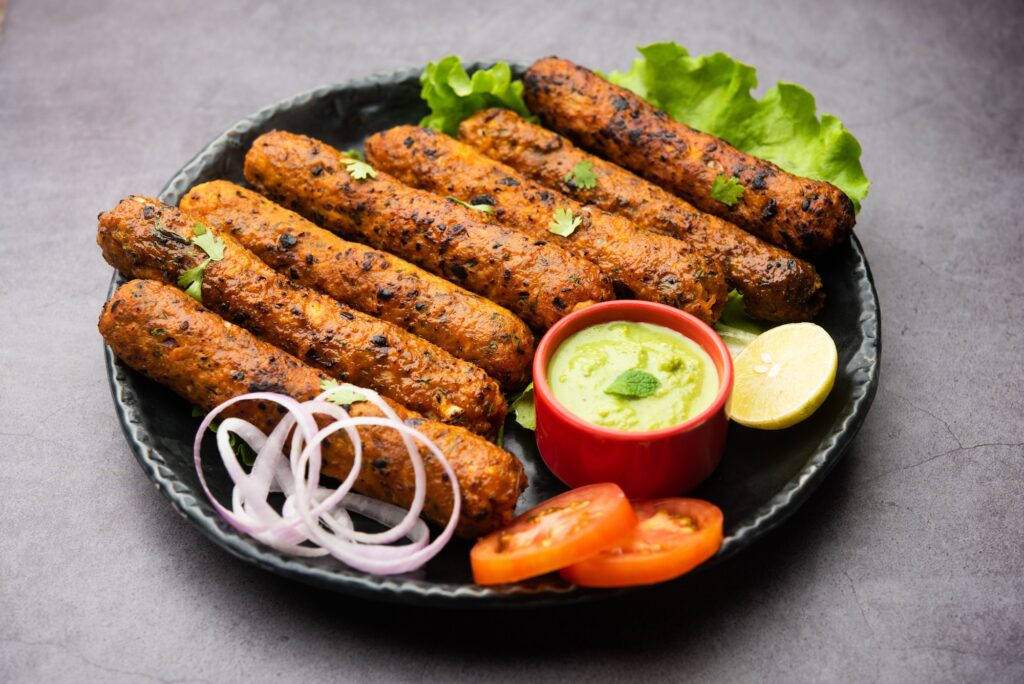 Seekh kabab served in plate with green chutney